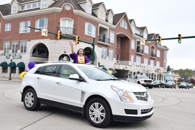 Graduate out of white car.jpg